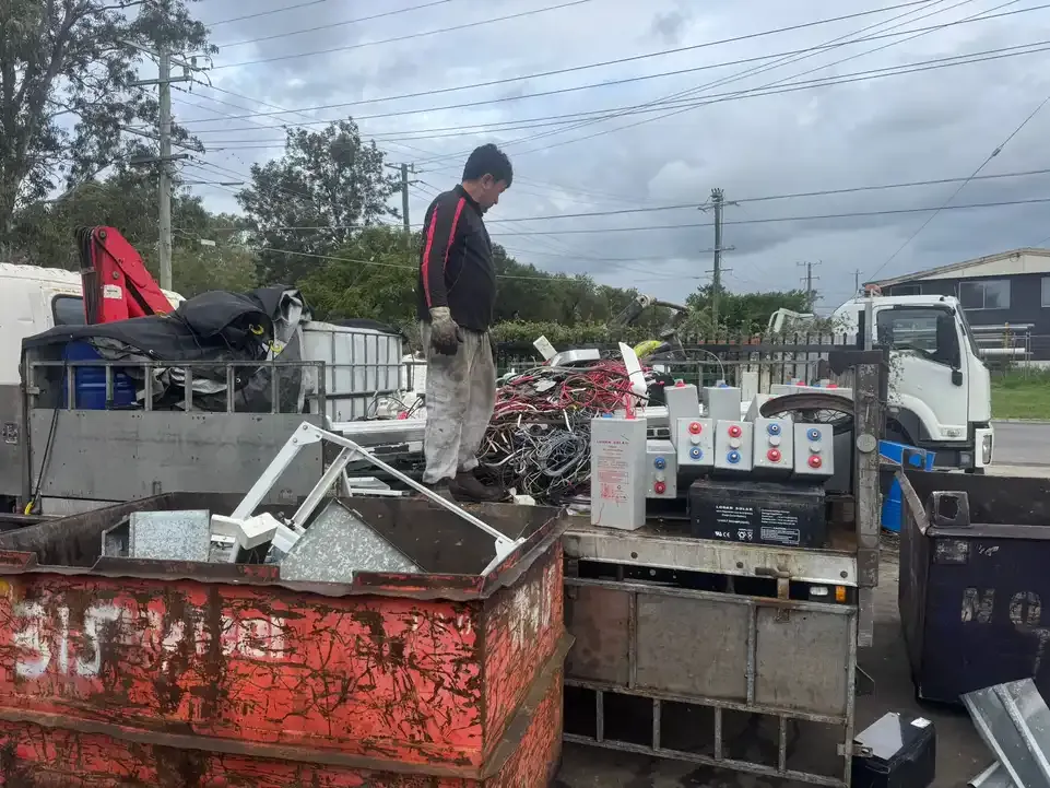 A loaded truck tray with sorted batteries, cable and skip bins back at the yard.